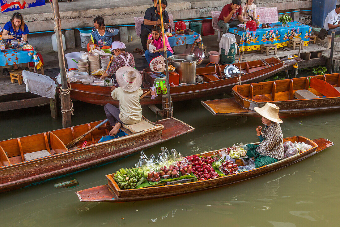 Thai vendors on their boats in the Damnoen Saduak Floating Market in Thailand.