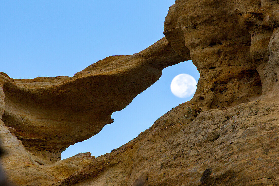 Moon and Graceful Arch in a remote desert area near Aztec in northwest New Mexico.