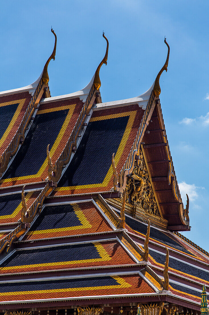 Roof detail of the Temple of the Emerald Buddha at the Grand Palace complex in Bangkok, Thailand. The elaborate chofa, bai raka and hong hongse are shown.