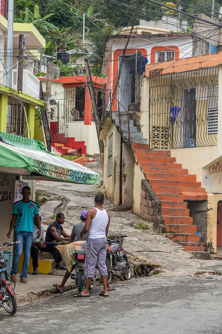 Scene on a hilly street in a residential neighborhood of Samana, Dominican Republic.