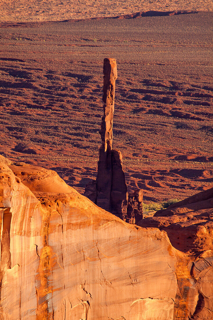 Telephoto view of the Totem Pole in Monument Valley from Hunt's Mesa in the Monument Valley Navajo Tribal Park in Arizona.