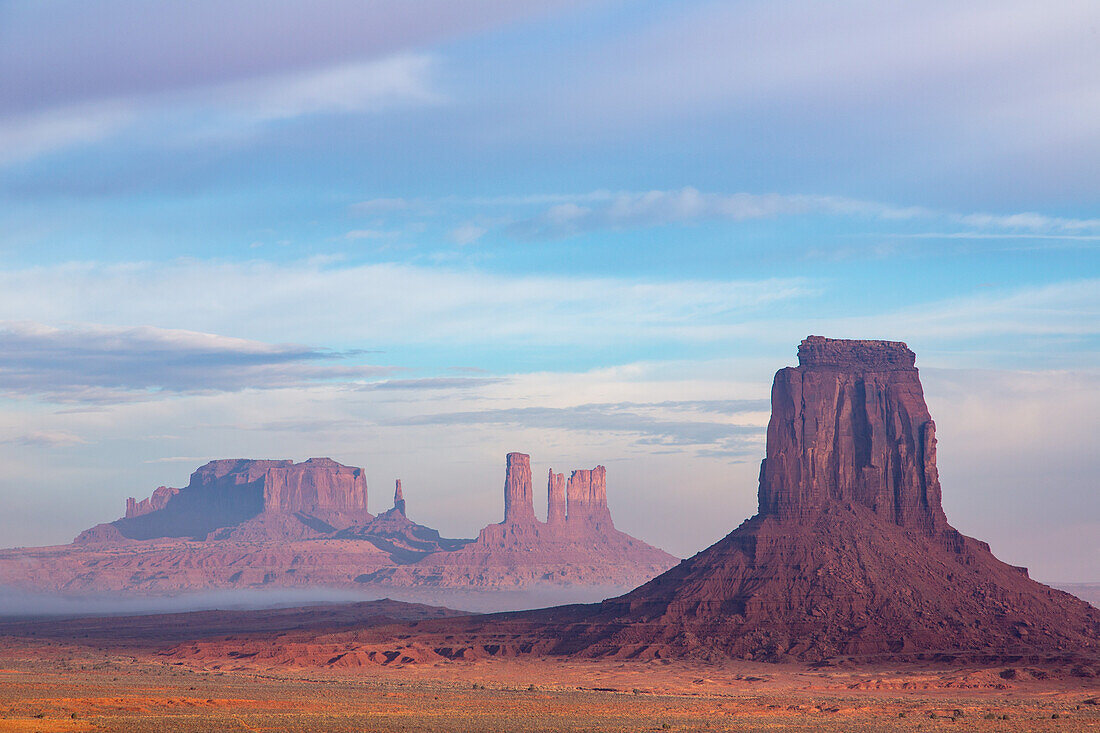 Foggy morning North Window view of the Utah monuments in the Monument Valley Navajo Tribal Park in Arizona. L-R: Brigham's Tomb, King on the Throne, Castle Butte, Bear and Rabbit, Stagecoach, East Mitten Butte.
