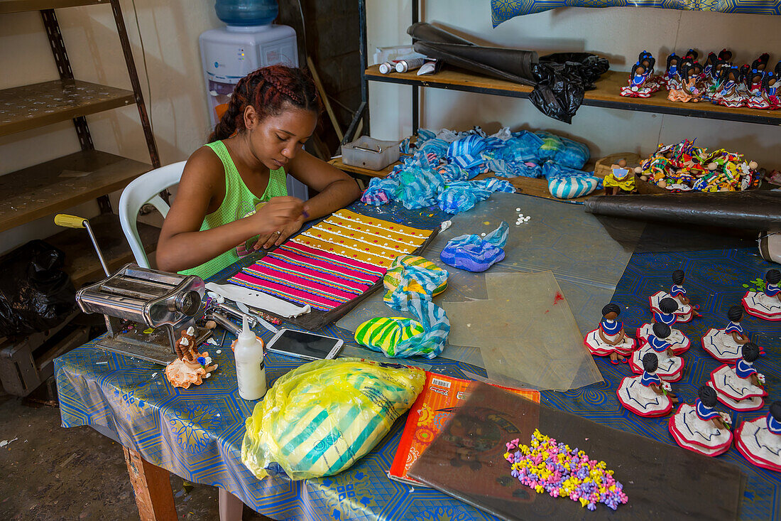 Ein Arbeiter stellt in einer Heimwerkstatt in der Dominikanischen Republik dominikanische gesichtslose Puppen her. Die gesichtslosen Puppen repräsentieren die ethnische Vielfalt der Dominikanischen Republik.