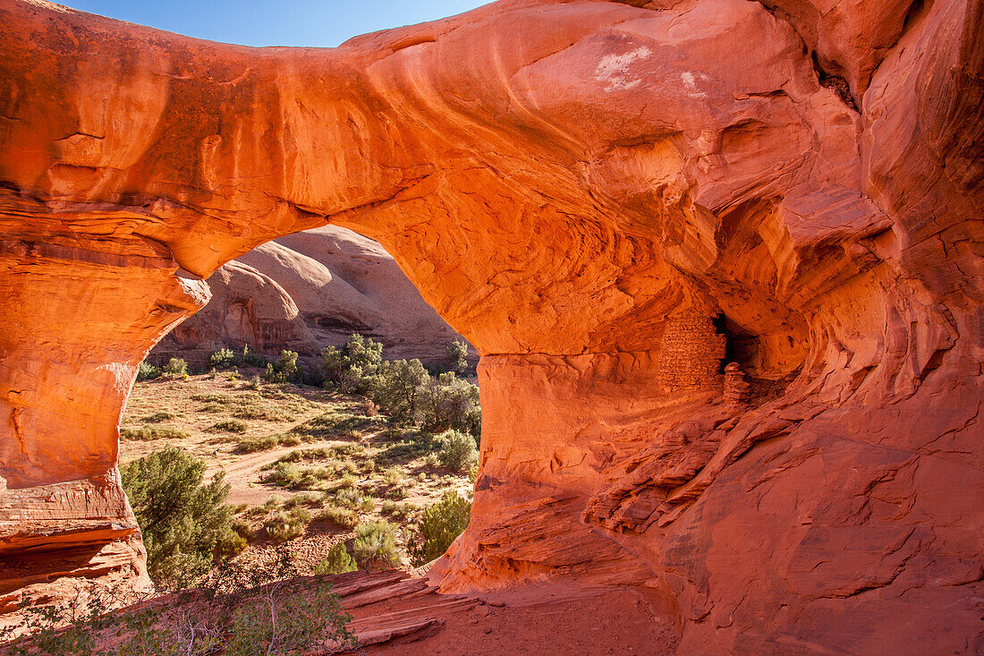 An Ancestral Puebloan ruin inside Honeymoon Arch in Mystery Valley in the Monument Valley Navajo Tribal Park in Arizona.