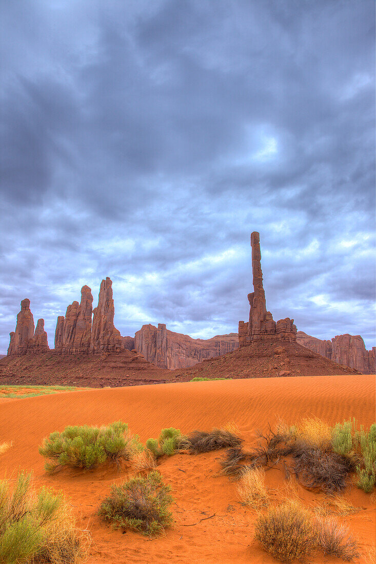 The Totem Pole & Yei Bi Chei on a cloudy day in the Monument Valley Navajo Tribal Park in Arizona.