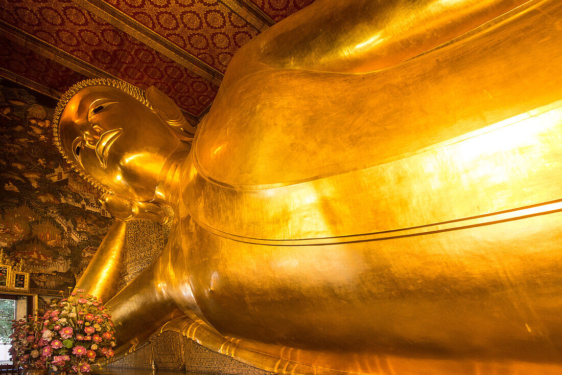 The giant Reclining Buddha statue, gilded with gold leaf, in the Wat Pho Temple in Bangkok, Thailand.