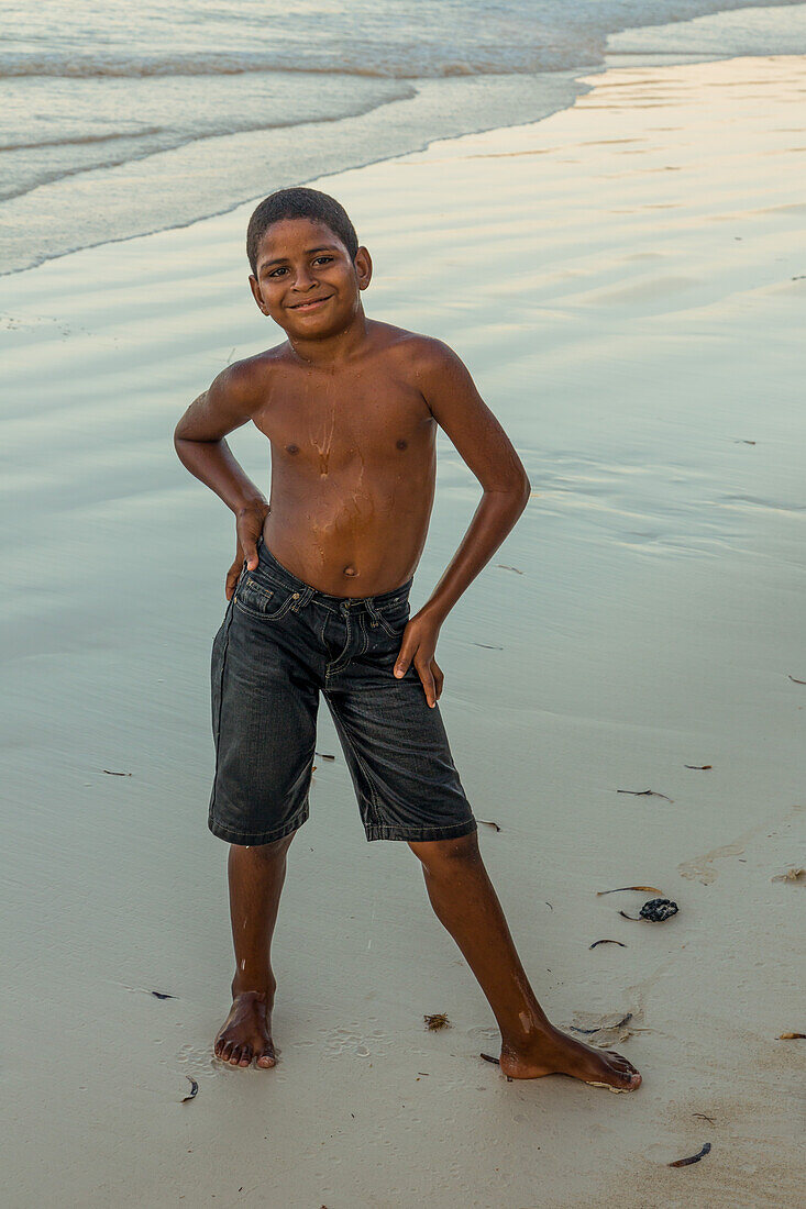 A young Dominican boy swims at the beach at Bahia de Las Galeras on the Samana Peninsula, Dominican Republic.