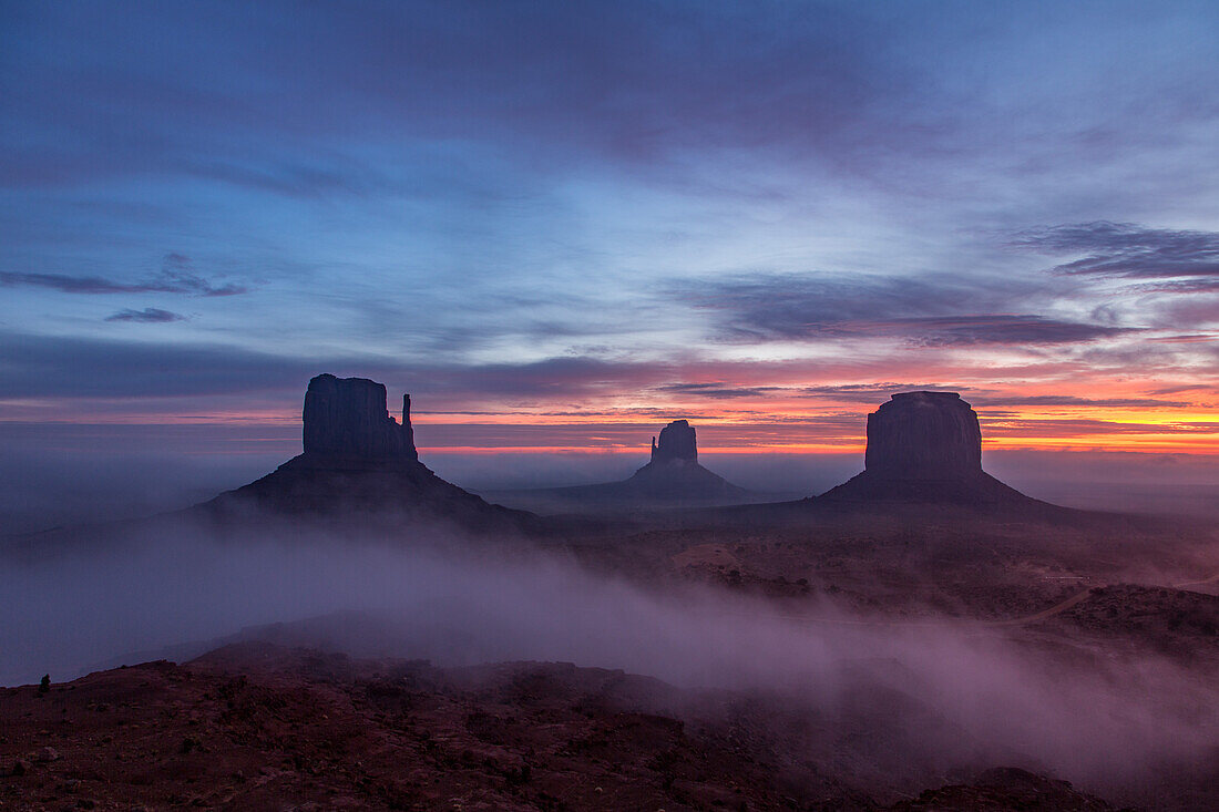 Colorful sunrise with ground fog in the Monument Valley Navajo Tribal Park in Arizona.