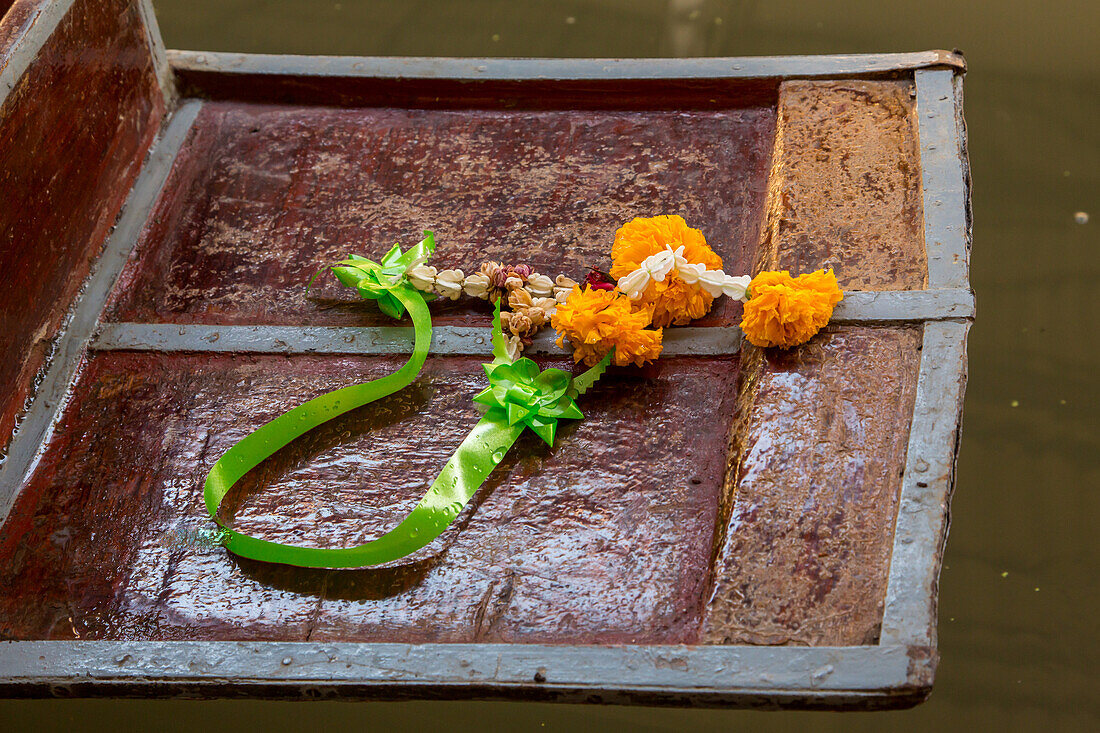 A Buddhist offering of flowers on a boat in the Damnoen Saduak Floating Market in Thailand.