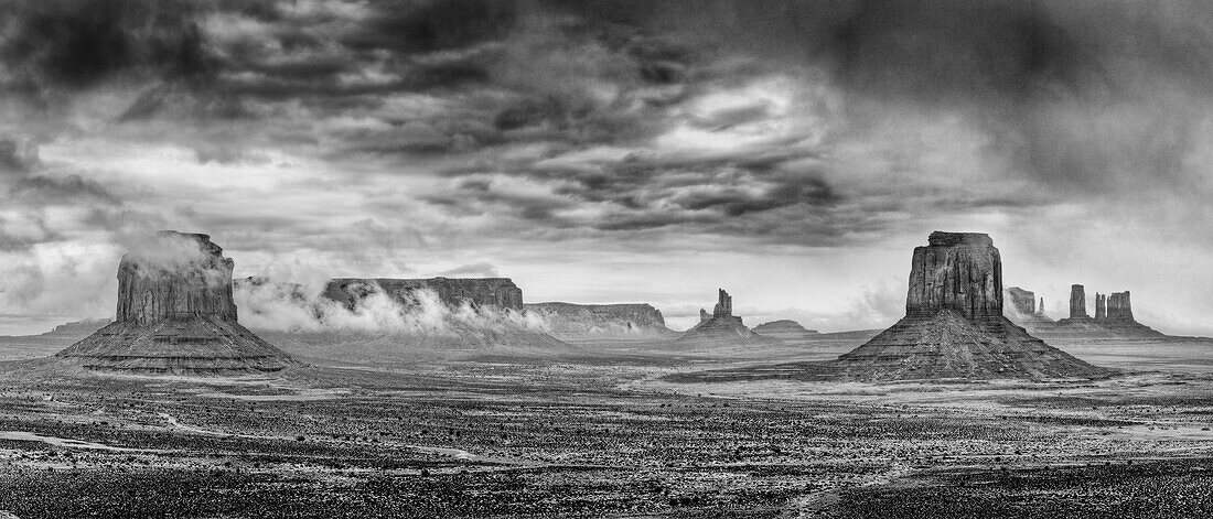 Stürmischer Blick auf das Monument Valley vom Artists Point im Monument Valley Navajo Tribal Park in Arizona. L-R: Merrick Butte, Sentinal Mesa mit Eagle Mesa im Hintergrund, Big Indian Chief mit Setting Hen im Hintergrund, East Mitten mit Brigham's Tomb im Hintergrund, King on his Throne, the Castle, the Bear and the Rabbit und the Stagecoach