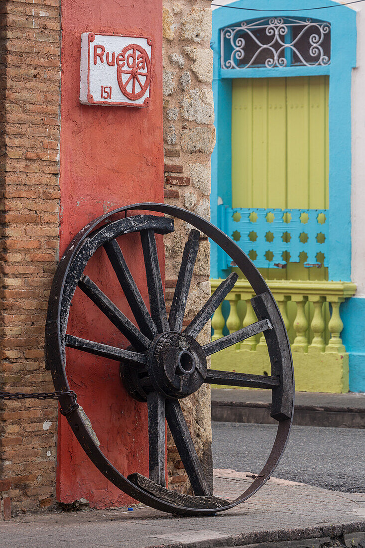 Old wagon wheel. Architectural detail in the old Colonial City of Santo Domingo, Dominican Republic. A UNESCO World Heritage Site in the Dominican Republic.