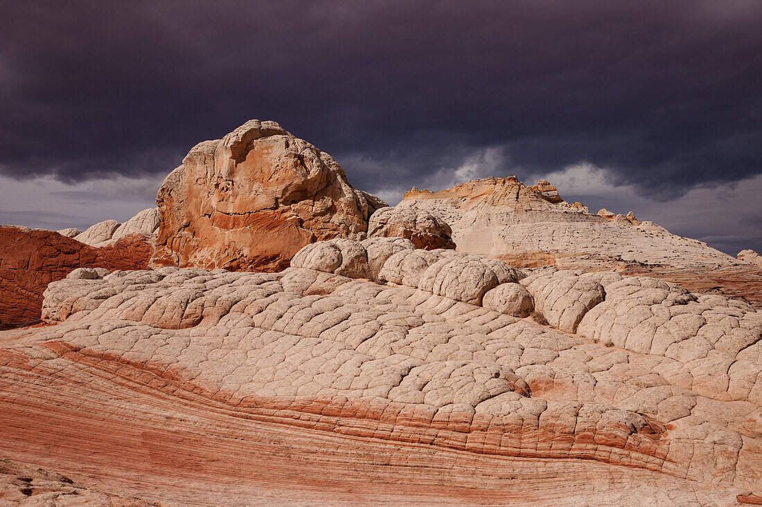Stormy clouds over colorful eroded sandstone formations. White Pocket Recreation Area, Vermilion Cliffs National Monument, Arizona.