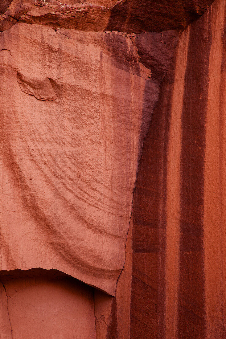 Colorful stripes of mineral deposits called desert varnish on sandstone in the Monument Valley Navajo Tribal Park in Arizona.