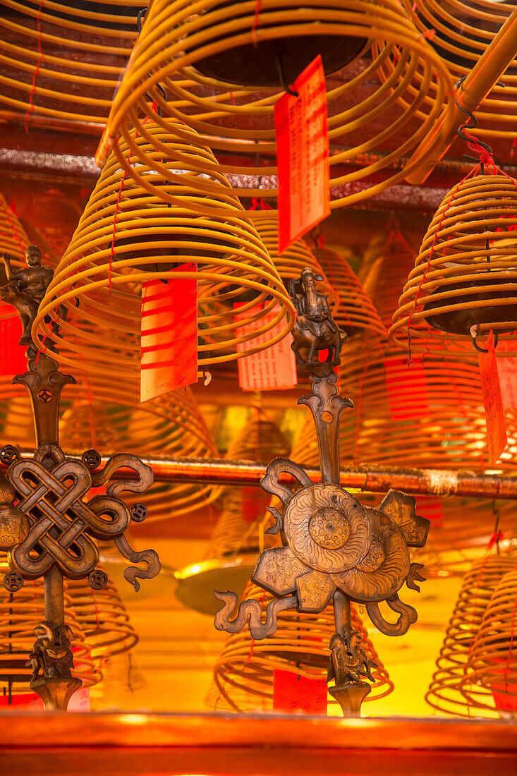 Burning incense coils send prayers to heaven in the Man Mo Temple, a Buddhist temple in Hong Kong, China.