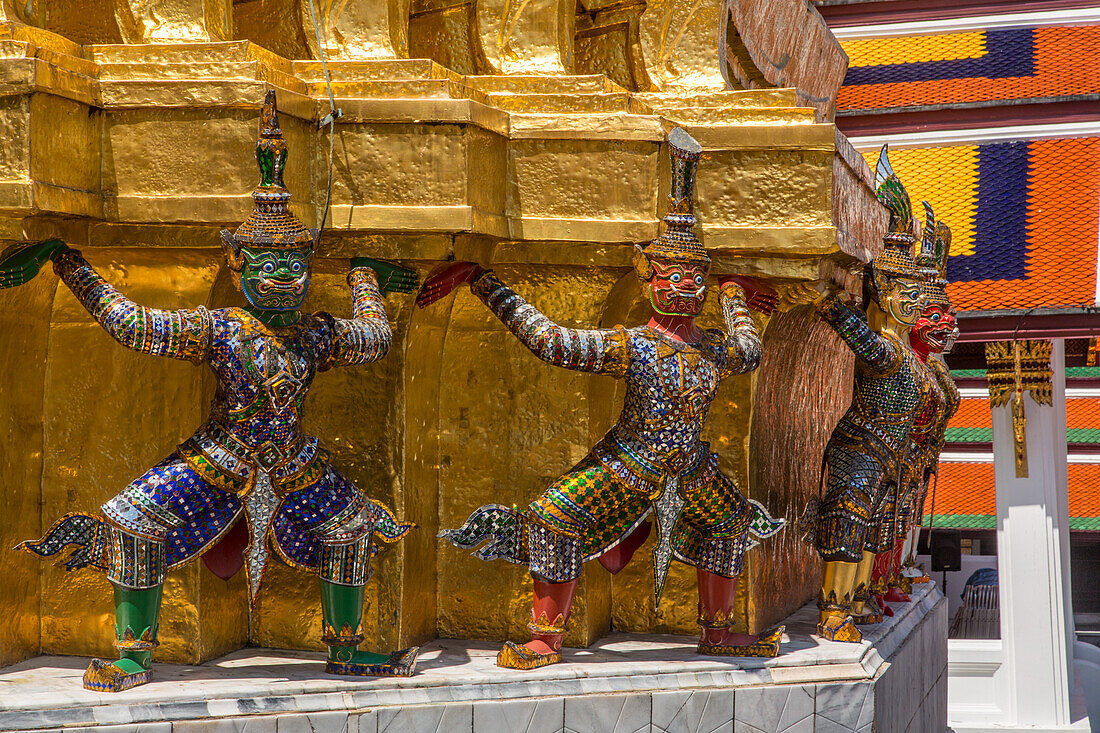 Small yaksha guardian statues at the Temple of the Emerald Buddha complex in the Grand Palace grounds in Bangkok, Thailand. A yaksha or yak is a giant guardian spirit in Thai lore.