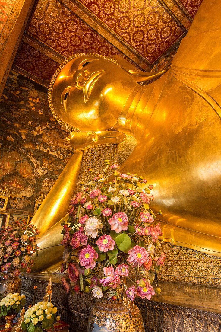 The giant Reclining Buddha statue, gilded with gold leaf, in the Wat Pho Temple in Bangkok, Thailand.