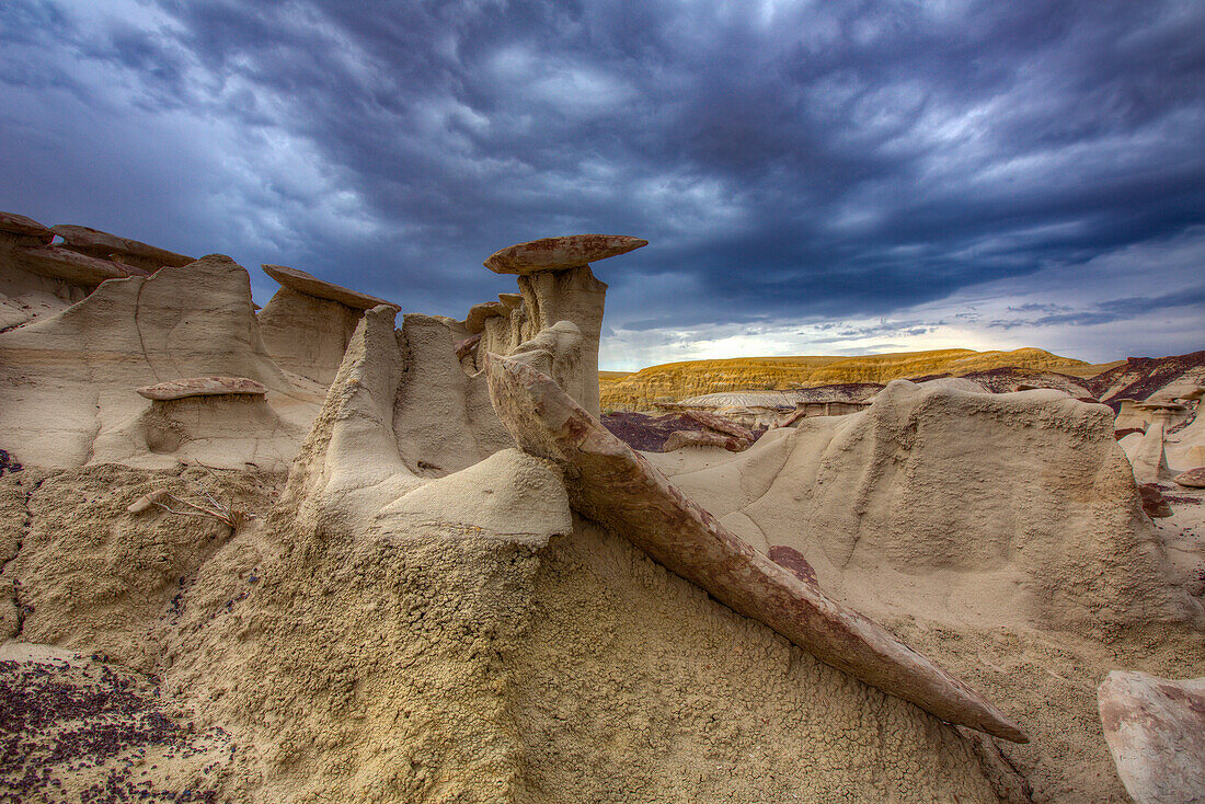 Sandstone caprocks on hoodoos in the colorful clay hills in the badlands of the San Juan Basin in New Mexico.