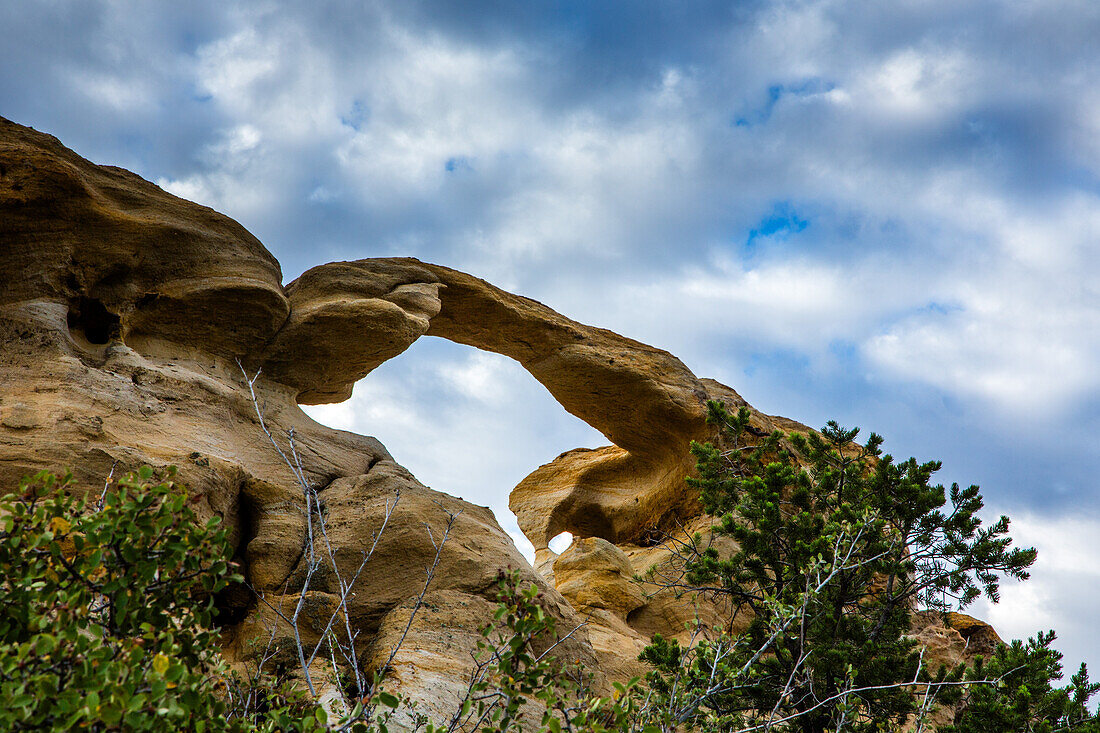 Blue sky and clouds over Graceful Arch in a remote desert near Aztec in northwestern New Mexico.