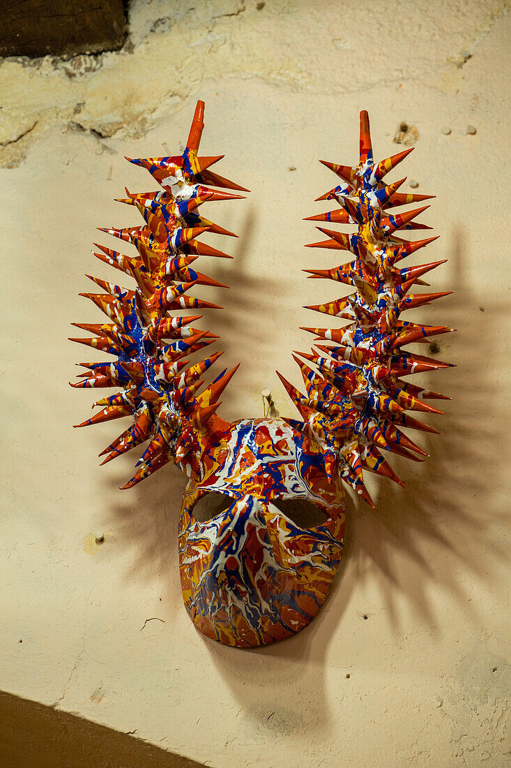 A Los Pepines lechone carnival mask from Santiago in a shop in the Mercado Modelo in Santo Domingo, Dominican Republic.