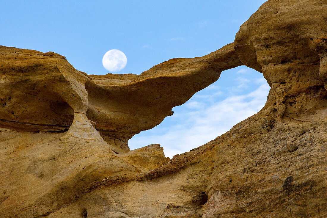 Moon and Graceful Arch in a remote desert area near Aztec in northwest New Mexico.