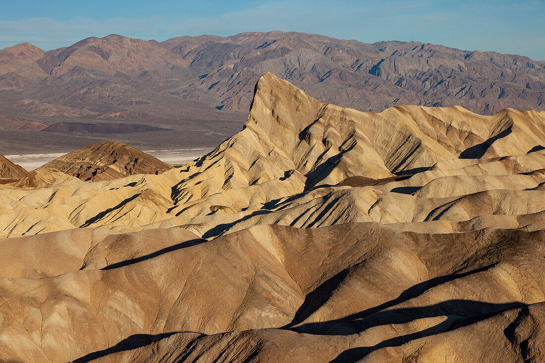 Manly Beacon & eroded badlands of the Furnace Creek Formation at Zabriskie Point in Death Valley National Park in California. The Badwater Basin & Panamint Mountains arae behind.