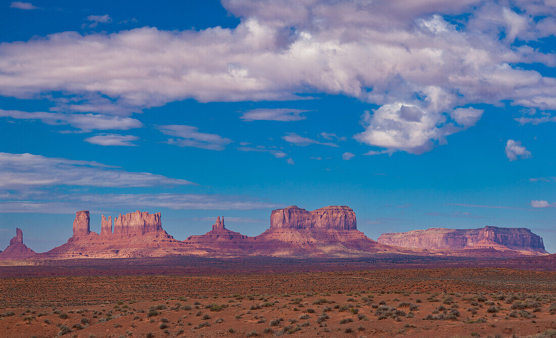 View of the Utah monuments from the northeast in the Monument Valley Navajo Tribal Park in Arizona & Utah. L-R: Big Indian Chief, Castle Butte, the Bear and the Rabbit, the Stagecoach, King on the Throne, Brigham's Tomb and Eagle Mesa.