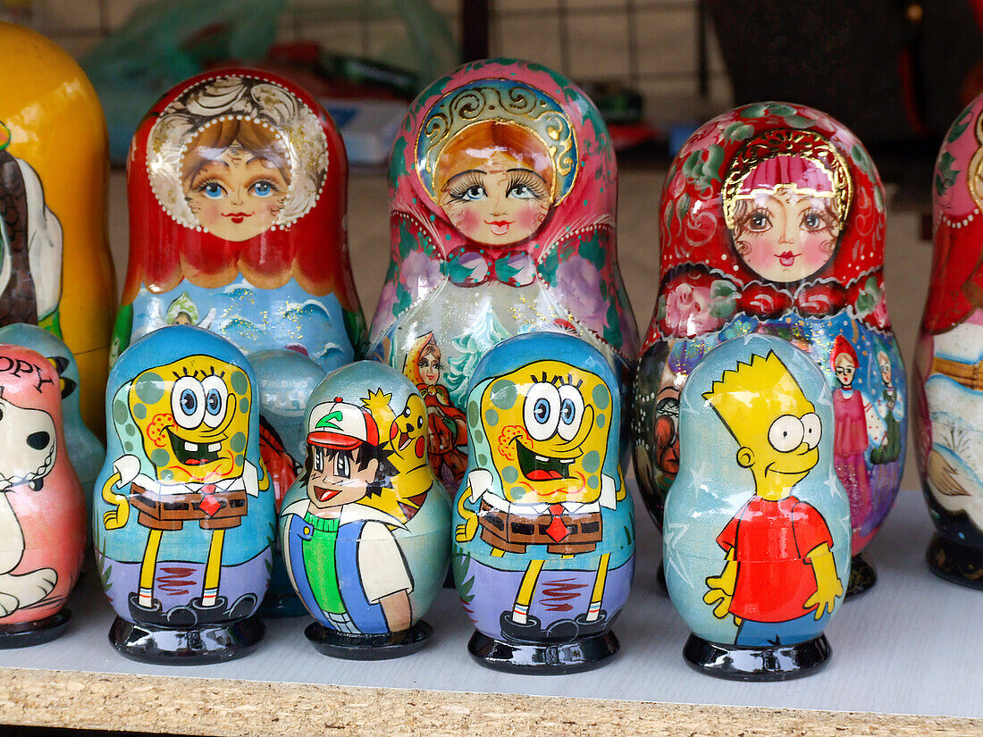 Wooden matryoshka dolls, some with more modern characters, for sale in a street market in the Old Town of Vilnius, Lithuania. A UNESCO World Heritage Site.