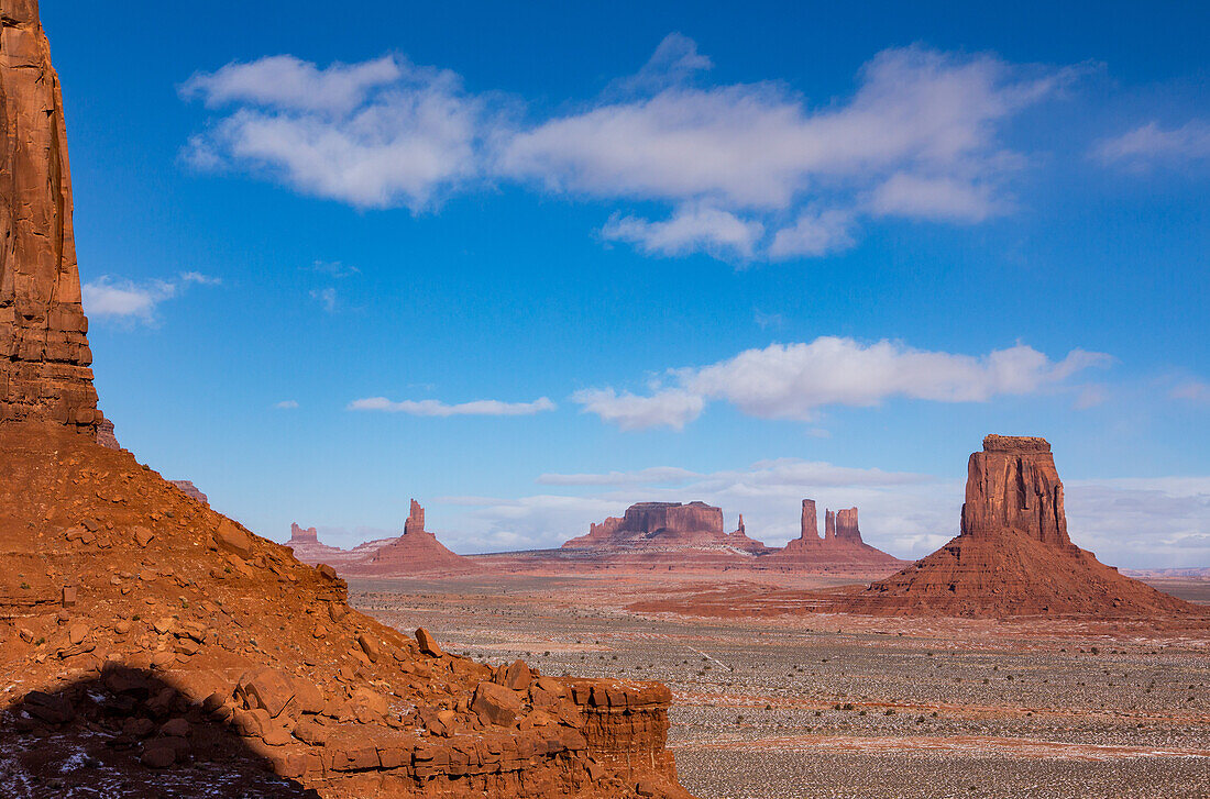 Morning North Window view of the Utah monuments in the Monument Valley Navajo Tribal Park in Arizona. L-R: Elephant Butte (foreground), Setting Hen, Big Indian Chief, Brigham's Tomb, King on the Throne, Castle Butte, Bear and Rabbit, Stagecoach, East Mitten Butte.