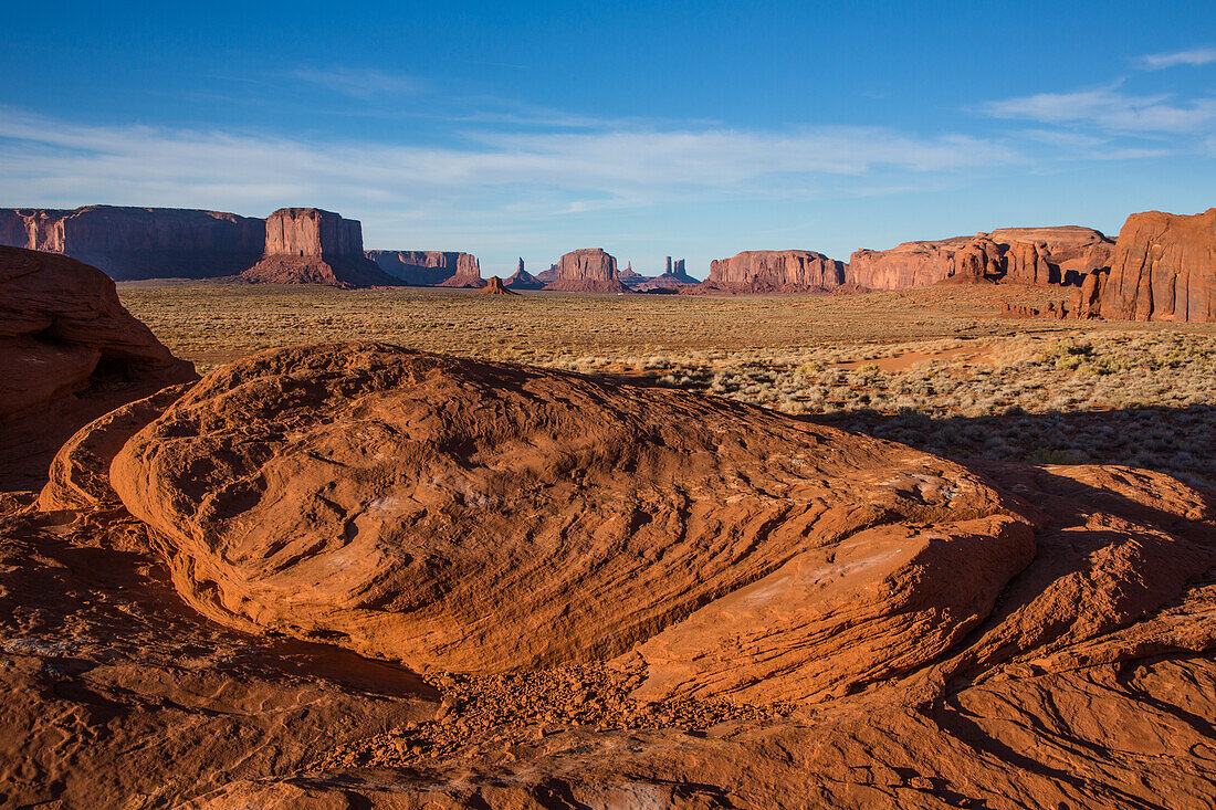 A sculpted sandstone boulder in front of the monuments in the Monument Valley Navajo Tribal Park in Arizona.