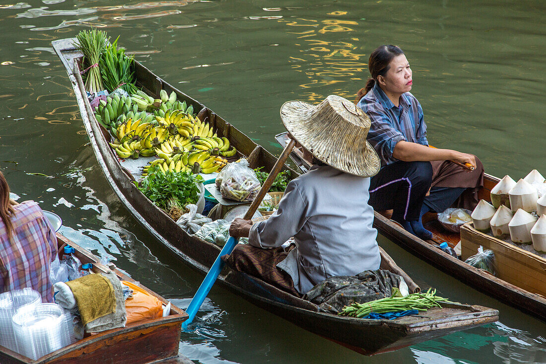 Thai vendors on their boats in the Damnoen Saduak Floating Market in Thailand.