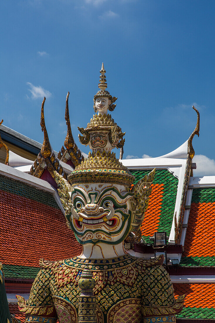 A yaksha guardian statue at the Temple of the Emerald Buddha complex in the Grand Palace grounds in Bangkok, Thailand. A yaksha or yak is a giant guardian spirit in Thai lore.