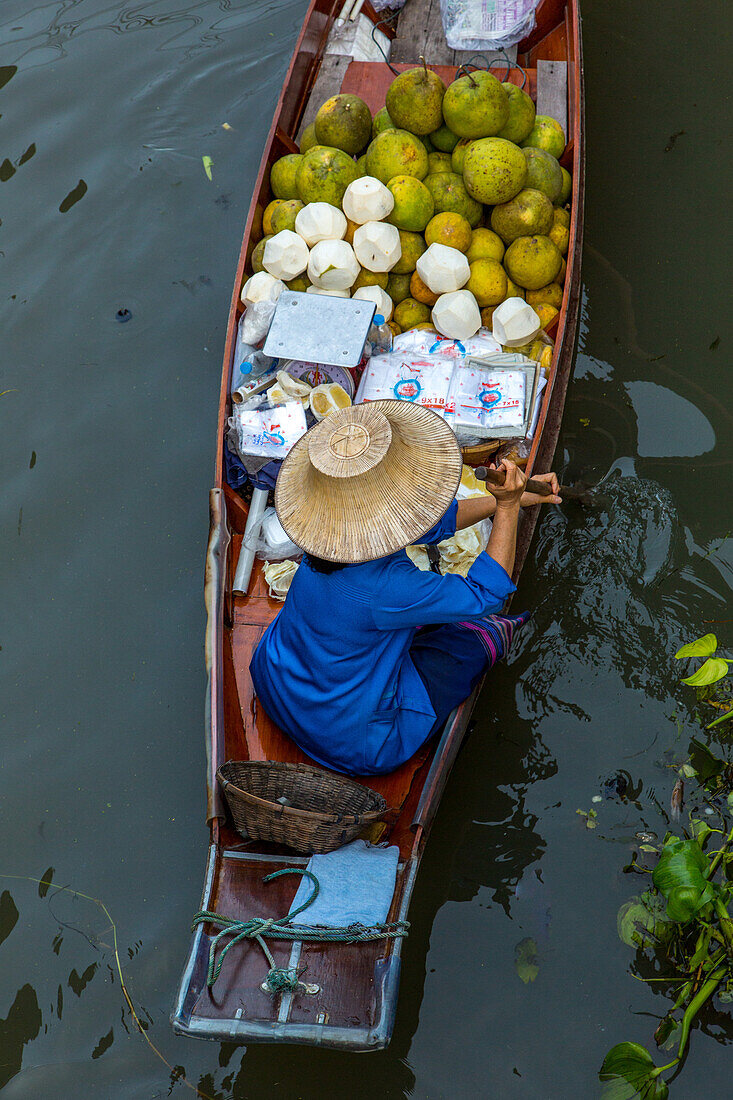 Thai vendors on their boats in the Damnoen Saduak Floating Market in Thailand.