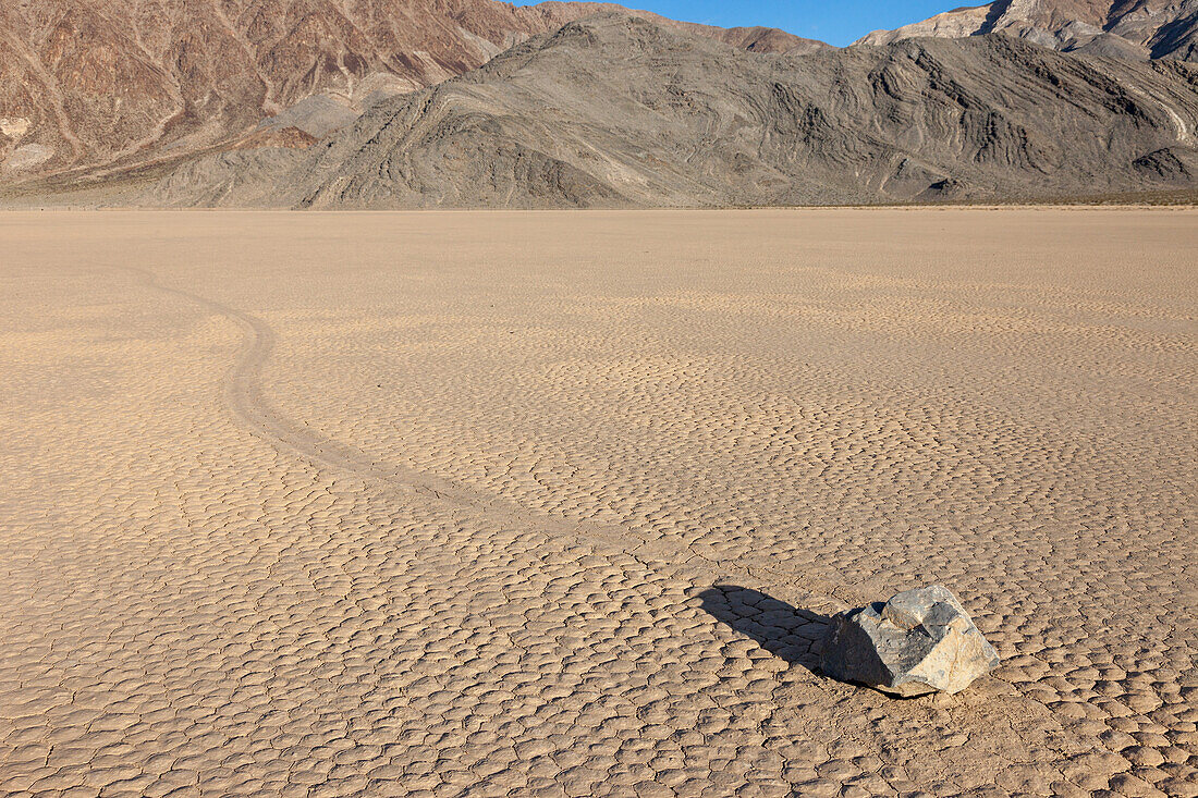 Sailing stone & track on the Racetrack Playa in Death Valley National Park in the Mojave Desert, California.