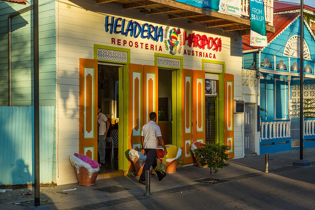 A colorful painted ice cream shop in a Victorian building facing Independence Square in Puerto Plata in the Dominican Repbulic.