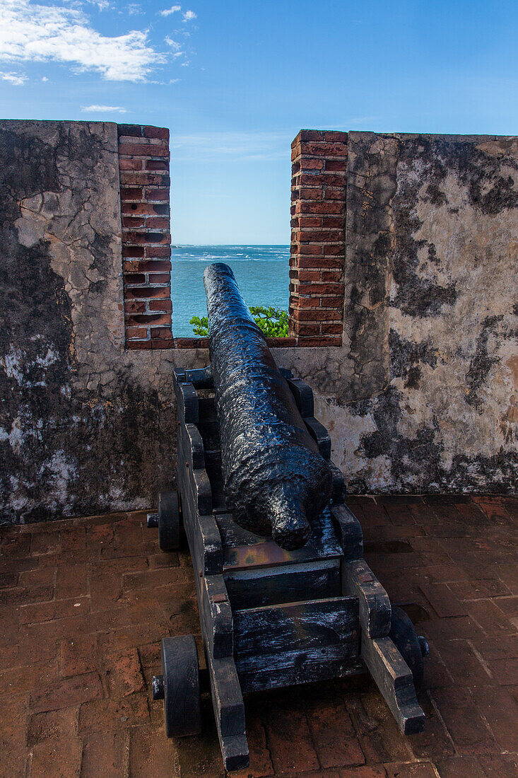 A colonial Spanish cannon overlooks the Atlantic Ocean at Fortaleza San Felipe, now a museum at Puerto Plata, Dominican Republic.