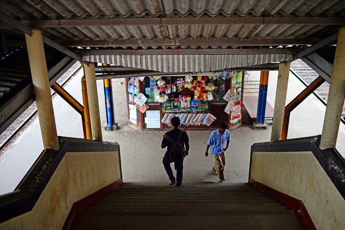 Two people and food stand in train station, Sri Lanka