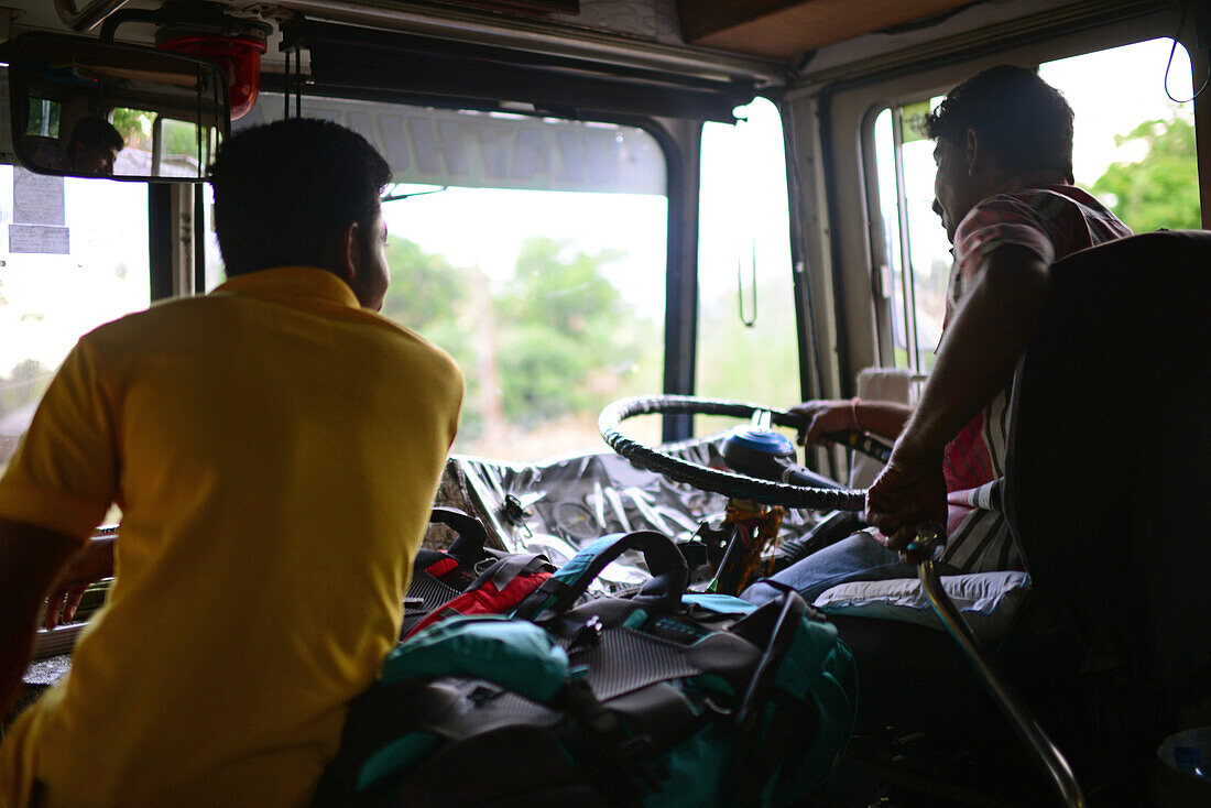 Bus driver and conductor talking, Sri Lanka