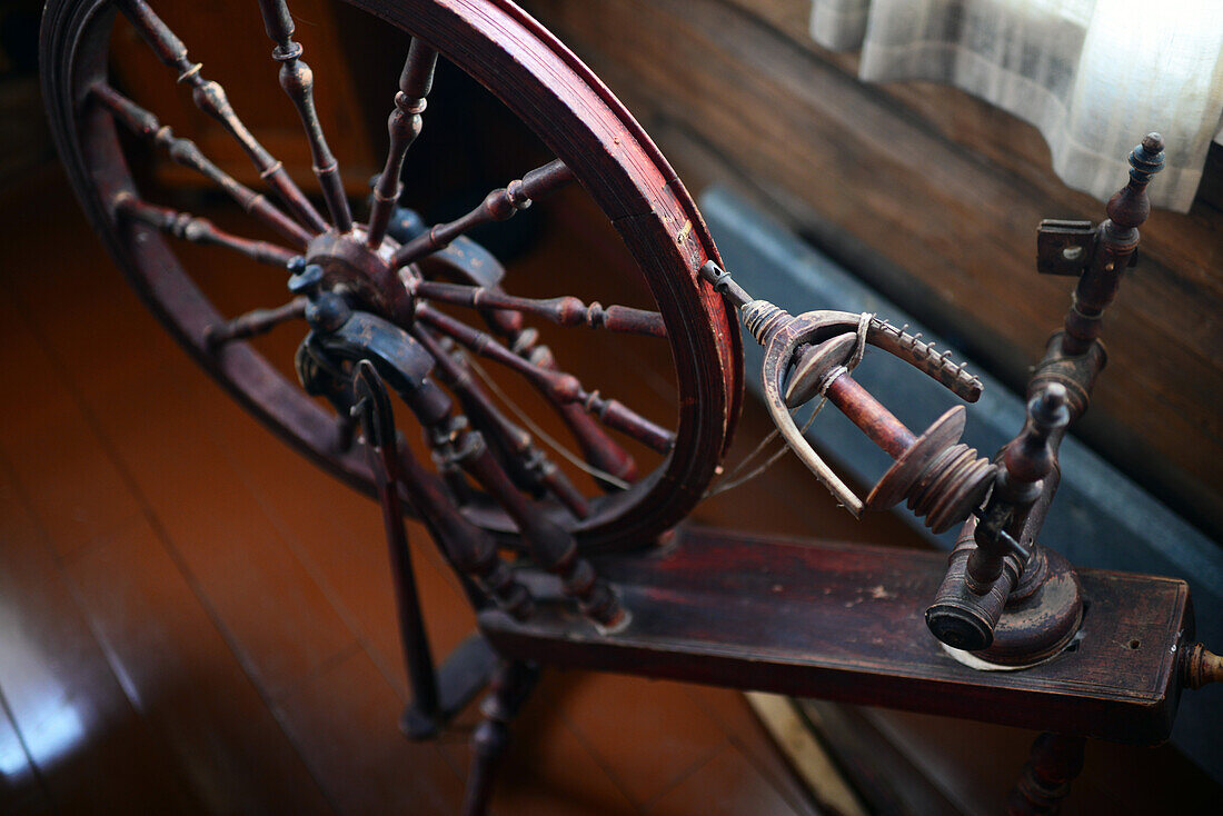 Old sewing wheel in traditional Finnish cottage at Kakslauttanen Arctic Resort, Saariselka, Finland