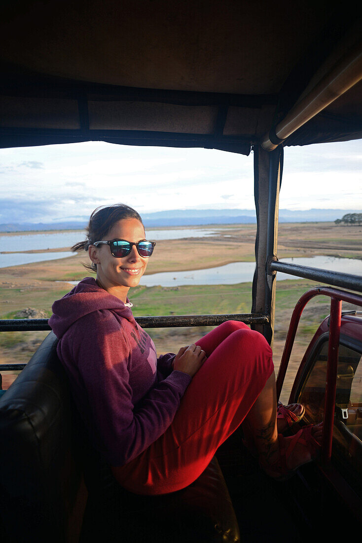 Young woman on safari jeep at Udawalawe National Park, Sri Lanka