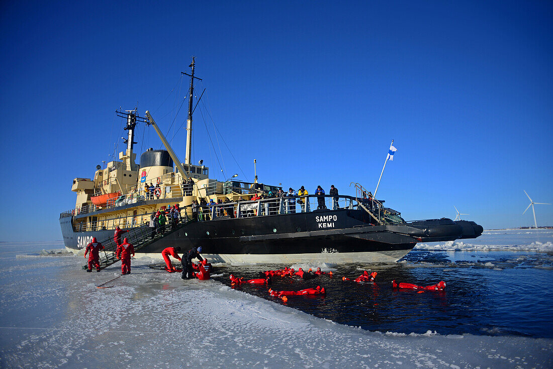 Swimming in the frozen sea during Sampo Icebreaker cruise, an authentic Finnish icebreaker turned into touristic attraction in Kemi, Lapland