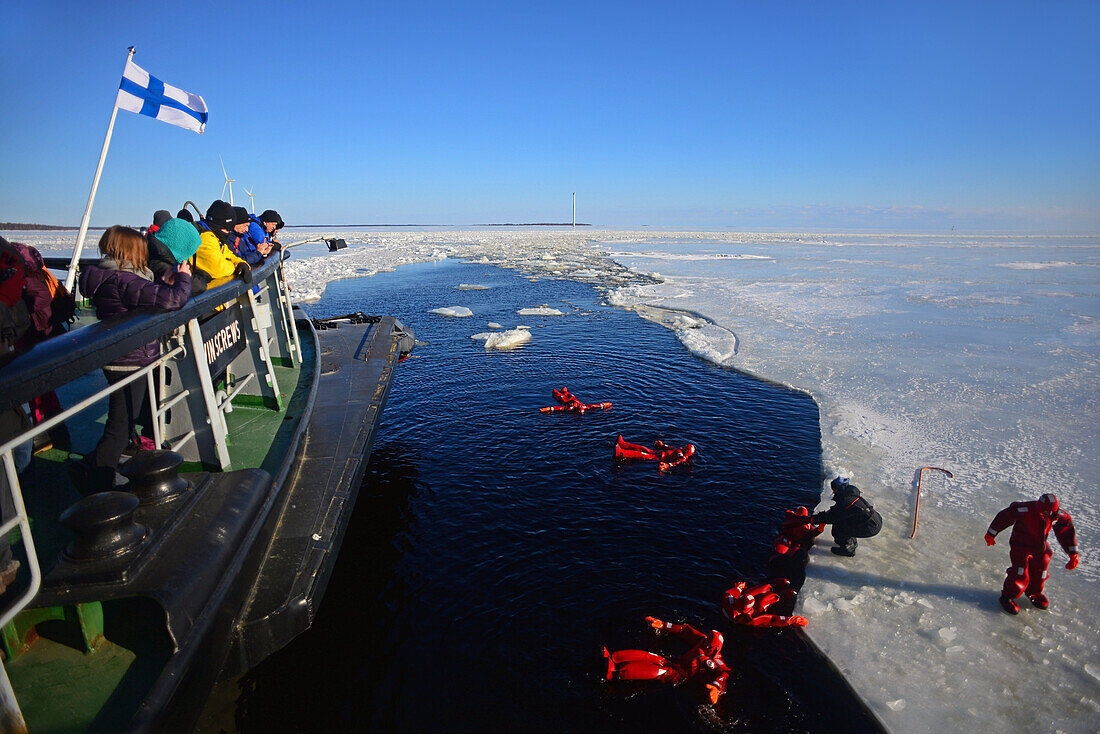 Swimming in the frozen sea during Sampo Icebreaker cruise, an authentic Finnish icebreaker turned into touristic attraction in Kemi, Lapland