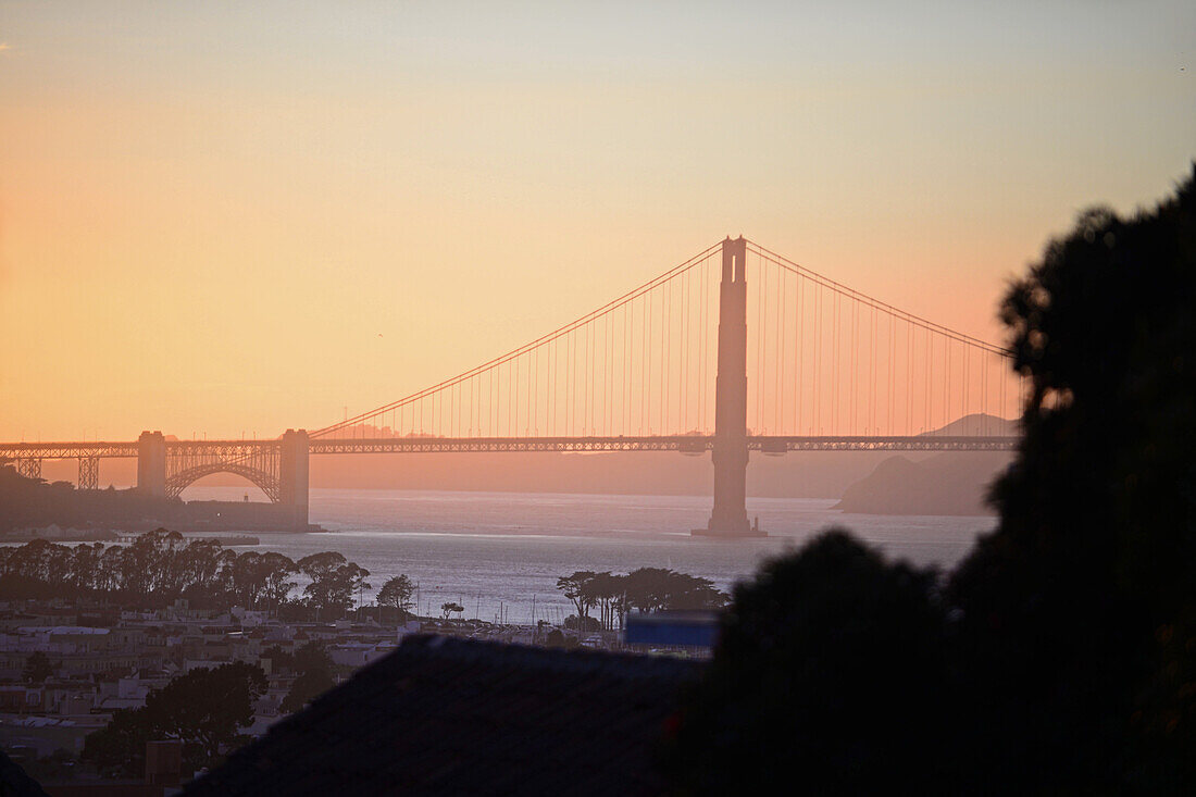 View of San Francisco and Golden Gate Bridge at sunset.