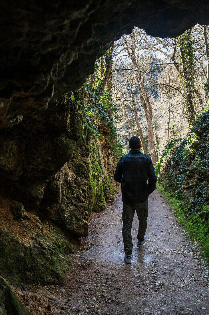 Young man visiting the Monasterio de Piedra Natural Park, located around the Monasterio de Piedra (Stone Monastery) in Nuevalos, Zaragoza, Spain