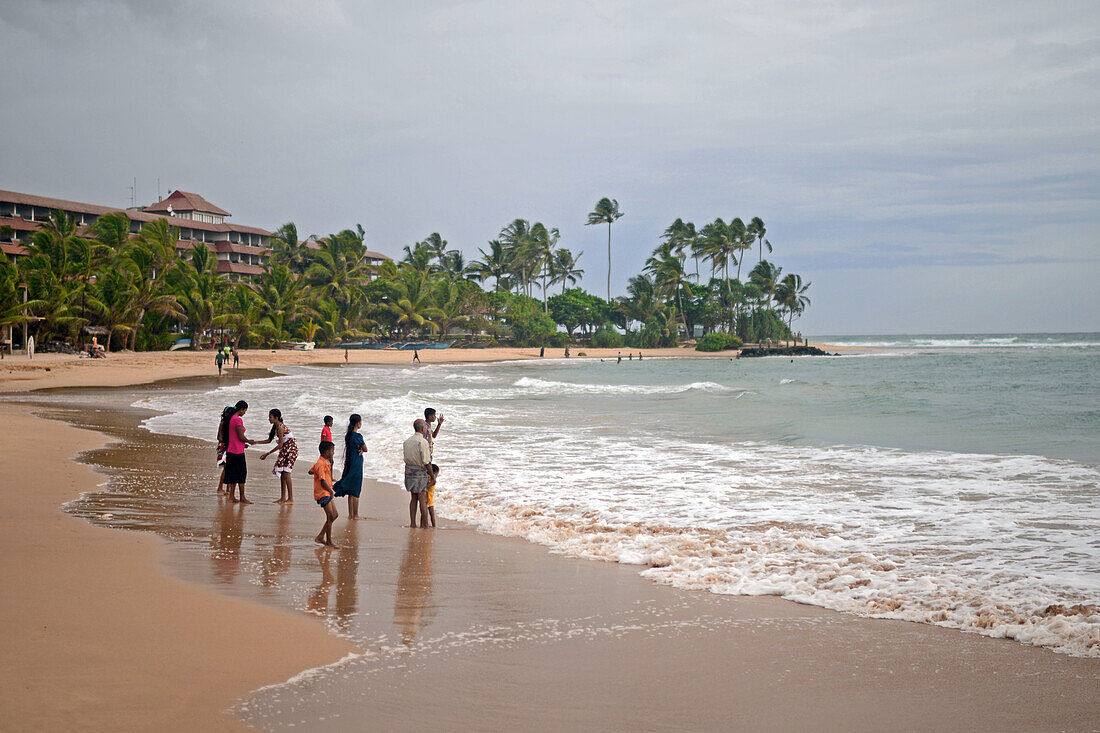 Big family on the beach at Hikkaduwa, Sri Lanka