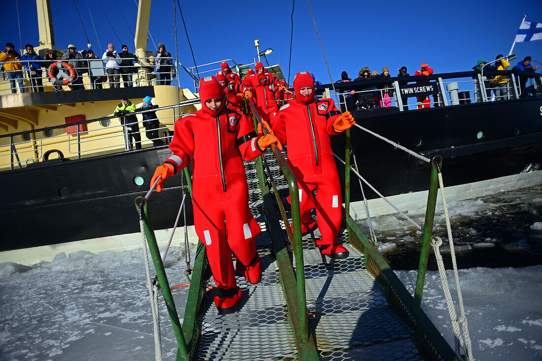 Swimming in the frozen sea during Sampo Icebreaker cruise, an authentic Finnish icebreaker turned into touristic attraction in Kemi, Lapland