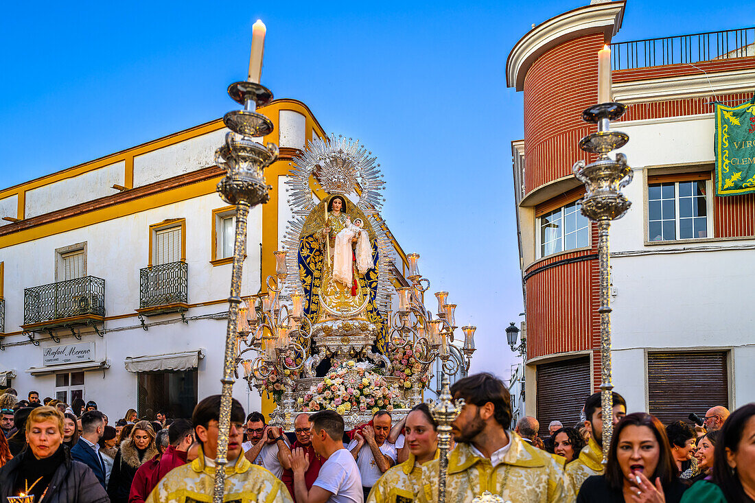 A solemn procession of Our Lady of the Rosary graces the streets of Carrion de los Cespedes, capturing the rich cultural and religious tapestry of Andalusia