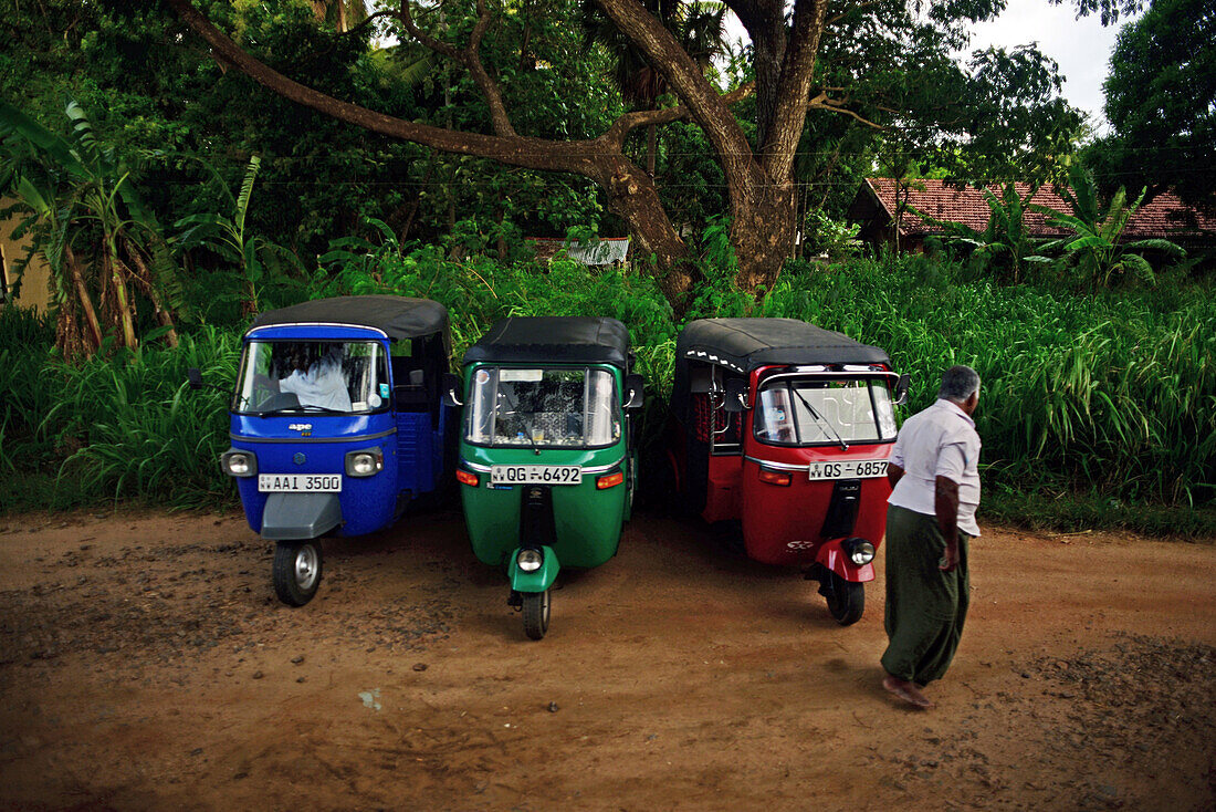 Three tuk tuks and driver, Sri Lanka