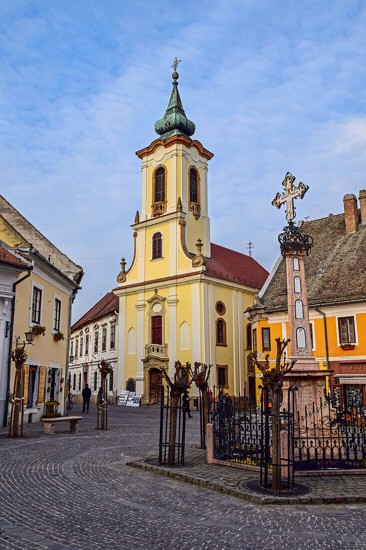 Memorial cross and the bell tower of the St John Roman Catholic Parish Church in Szentendre, a riverside town in Pest County, Hungary
