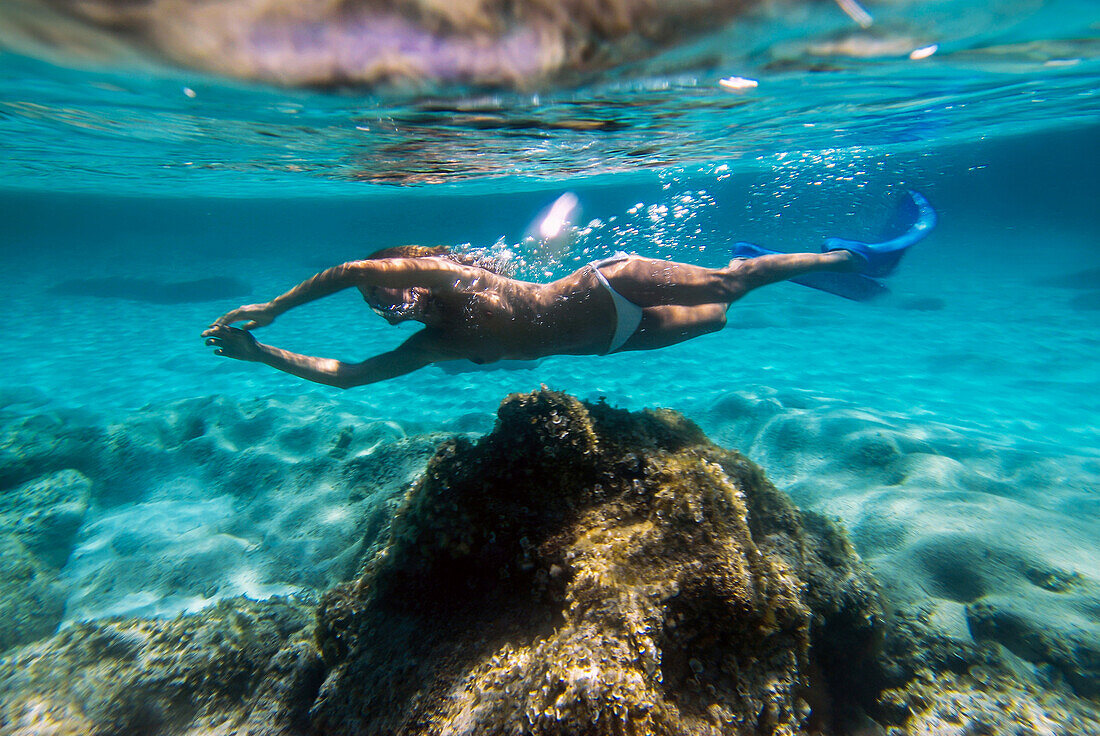 Woman underwater in Mitjorn beach in Formentera, Spain