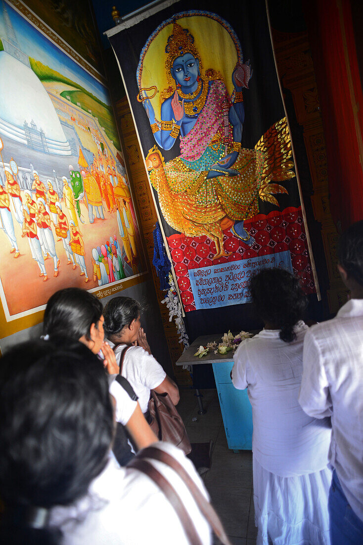 Group of people praying inside Abhayagiri Monastery in Anuradhapura, Sri Lanka